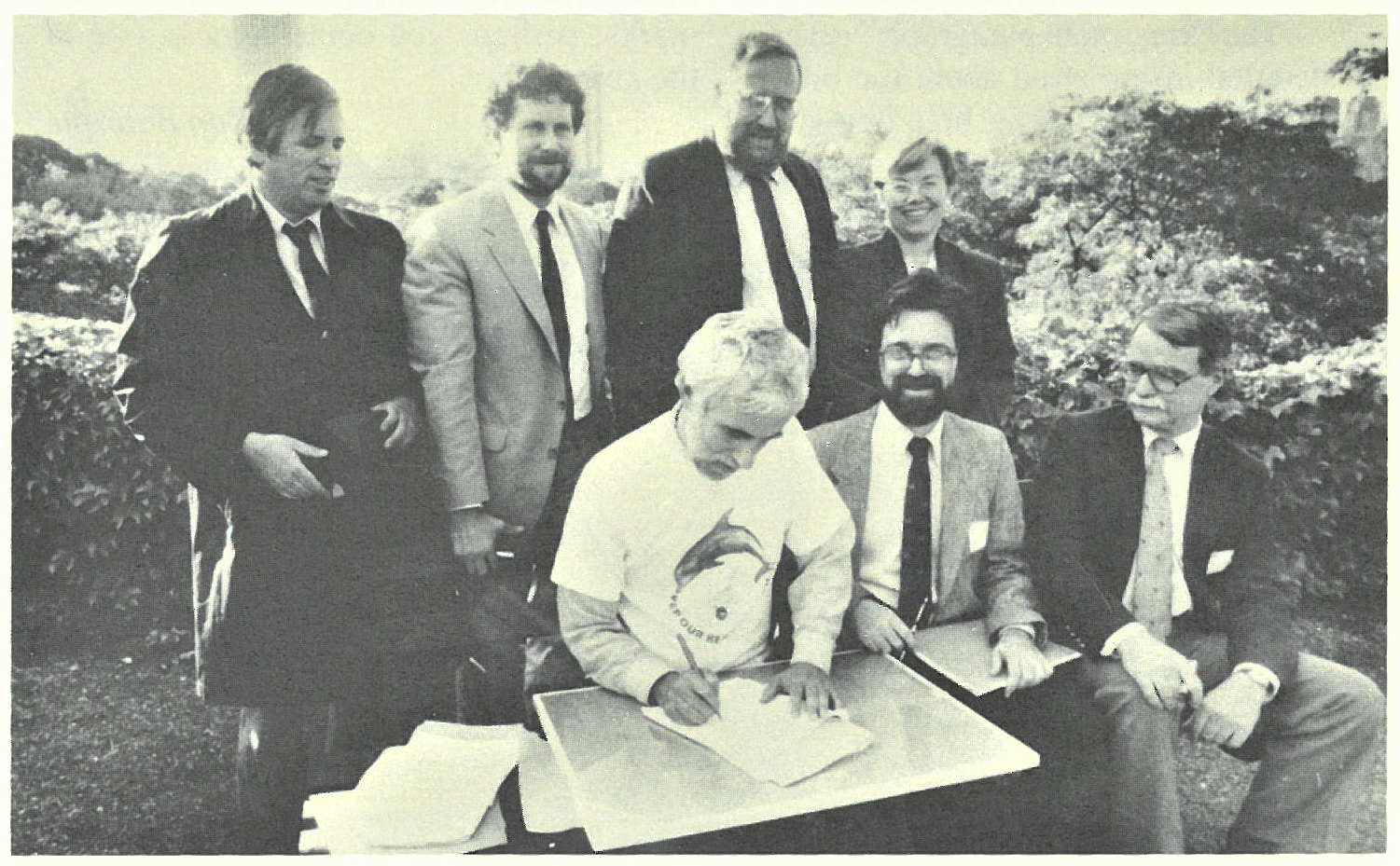 NYC Parks Commissioner Henry Stern signing over management of Dubos Point Sanctuary to NYC Audubon. Also seated (left to right): past Board Member Drew Lehman and past Board President and Secretary Geoffrey Cobb Ryan. Standing (left to right): Bernard Blum of Friends of Rockaway, Marc Matsil of NYC Parks, past Board President and Vice President Albert F. Appleton, and NYC Parks Deputy Commissioner Diana Chapin. Photo: Calvin Wilson/NYC Parks