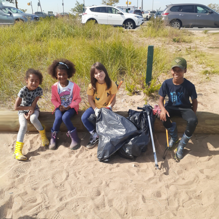 Young volunteers take a breather from cleaning North Channel Beach in Jamaica Bay. Photo: Aurora Crooks