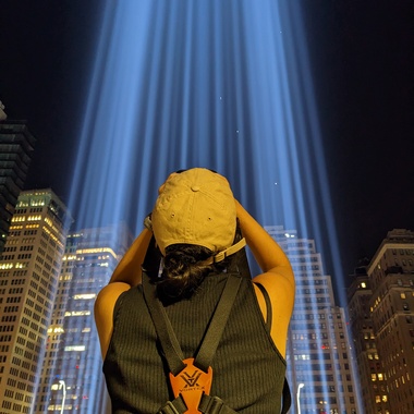 A volunteer joins NYC staff to monitor the 9/11 Tribute in Light memorial for birds trapped in the light beams. Photo: NYC Audubon