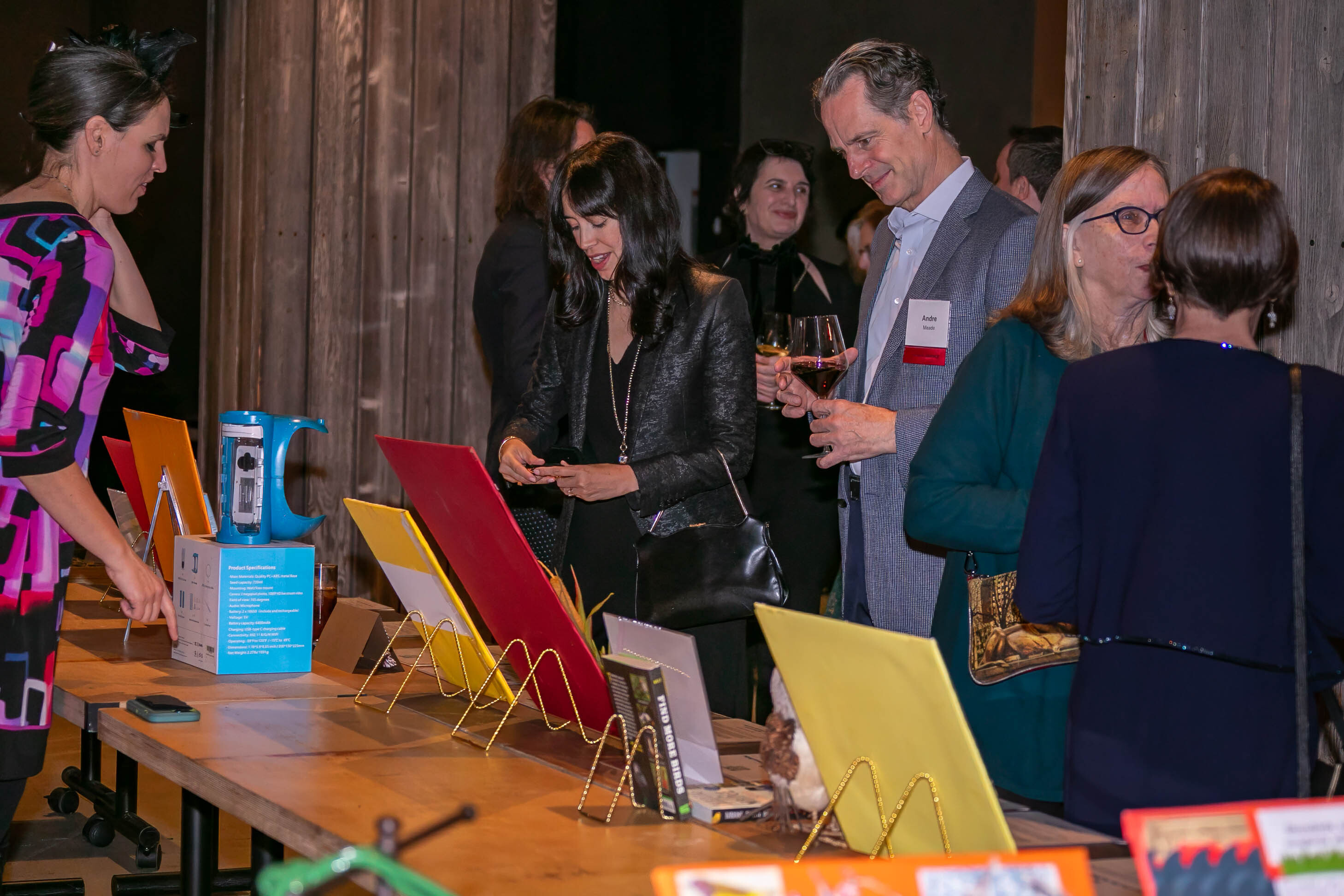 Volunteer Michelle Talich (left) helps bidders at the 2023 Fall Roost silent auction. Photo: Cyrus Gonzeles
